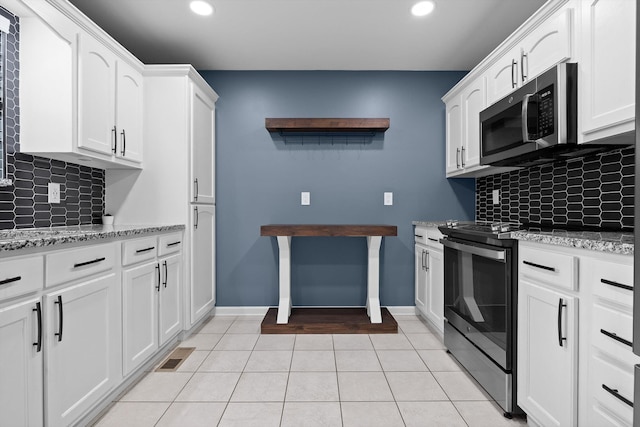 651 Howard Leonard Rd, Ringgold, GA 30736 - kitchen with stainless steel appliances, recessed lighting, backsplash, white cabinetry, and light tile patterned floors