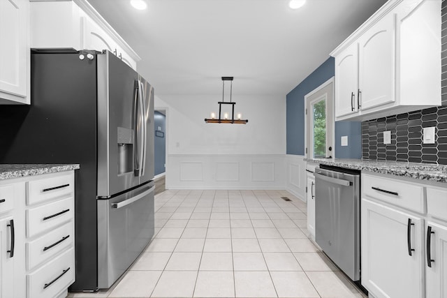 651 Howard Leonard Rd, Ringgold, GA 30736 - kitchen featuring appliances with stainless steel finishes, white cabinetry, a chandelier, a wainscoted wall, and recessed lighting