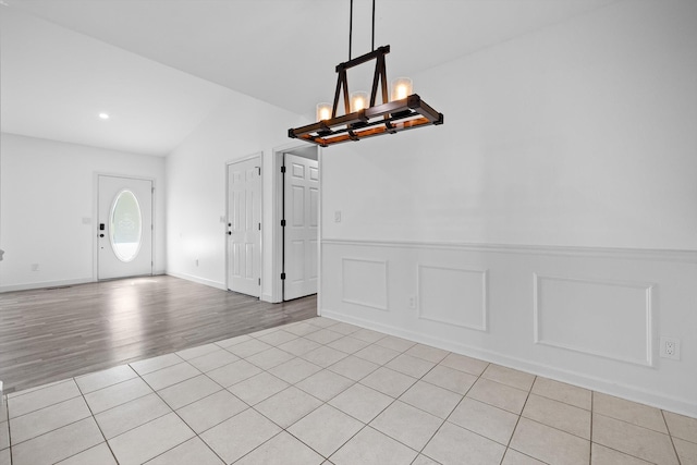 651 Howard Leonard Rd, Ringgold, GA 30736 - unfurnished dining area with a chandelier, light tile patterned floors, lofted ceiling, wainscoting, and recessed lighting