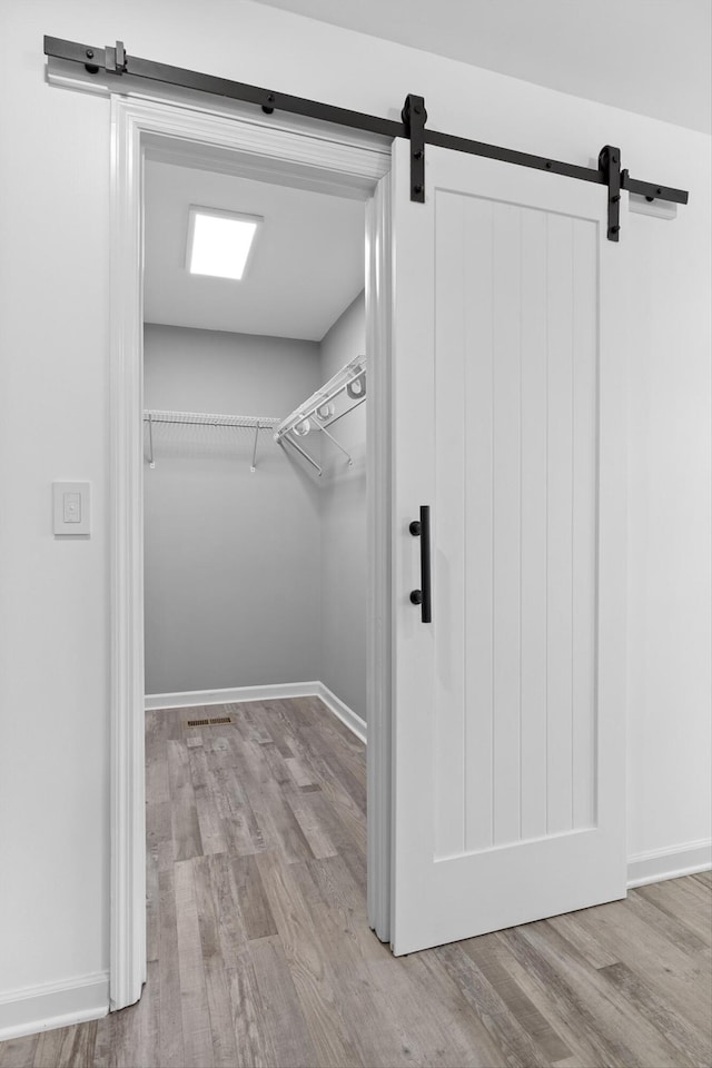 651 Howard Leonard Rd, Ringgold, GA 30736 - spacious closet featuring a barn door and wood finished floors