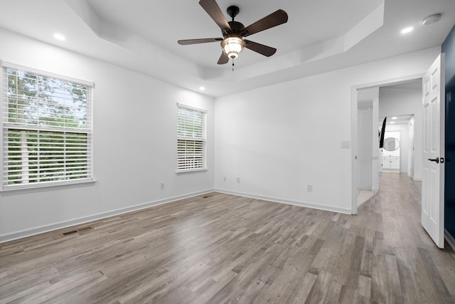 651 Howard Leonard Rd, Ringgold, GA 30736 - spare room with a tray ceiling, ceiling fan, plenty of natural light, light wood-style floors, and recessed lighting