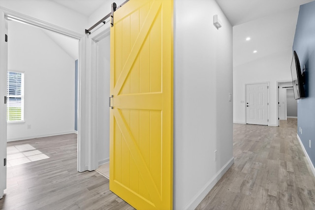651 Howard Leonard Rd, Ringgold, GA 30736 - hallway featuring a barn door, light wood-type flooring, and high vaulted ceiling