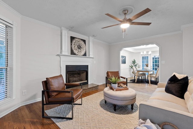 8512 Creek Stone Dr, Chattanooga, TN 37421 - living room featuring wood finished floors, arched walkways, a large fireplace, crown molding, and ceiling fan