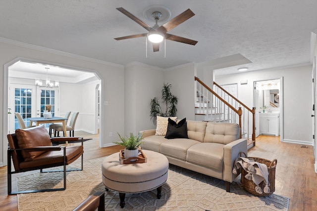8512 Creek Stone Dr, Chattanooga, TN 37421 - living area featuring light wood-type flooring, stairs, ceiling fan, a chandelier, and arched walkways