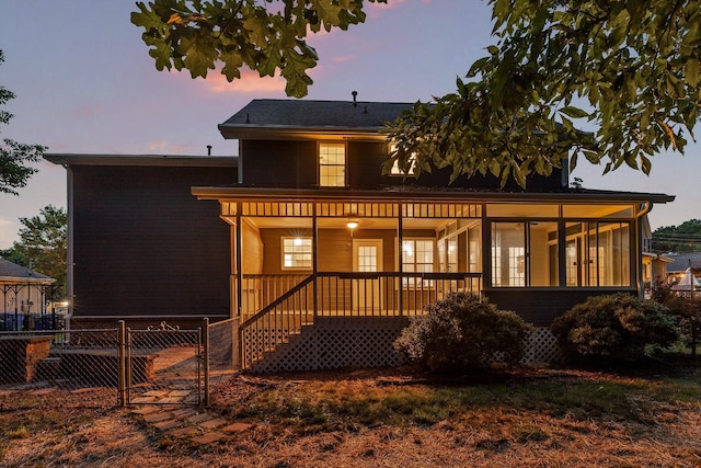 8512 Creek Stone Dr, Chattanooga, TN 37421 - back of house at dusk with a gate and brick siding