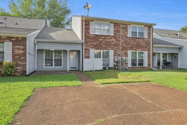 1259 Leaside Ln, Hixson, TN 37343 - rear view of house with a yard, brick siding, a shingled roof, and a patio