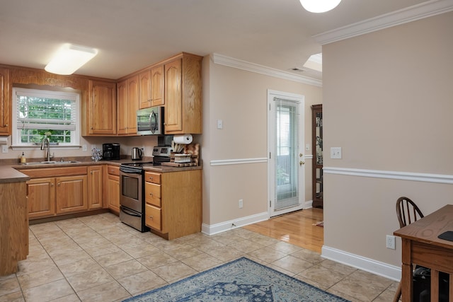 750 Windrush Loop, Chattanooga, TN 37421 - kitchen featuring stainless steel appliances, crown molding, light tile patterned floors, and dark countertops