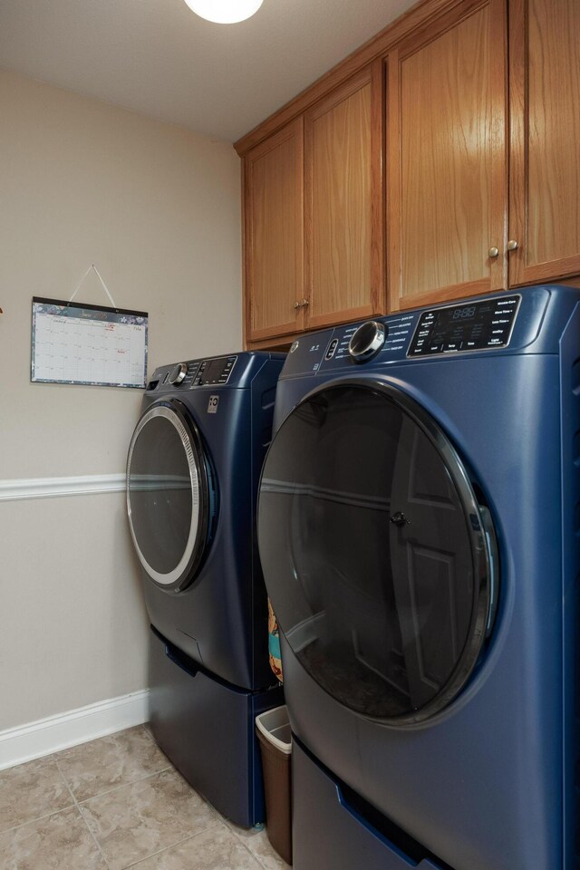 750 Windrush Loop, Chattanooga, TN 37421 - laundry room featuring cabinet space, washer and clothes dryer, and light tile patterned floors