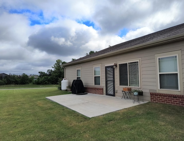 179 Trade Wind Dr, Fort Oglethorpe, GA 30742 - rear view of property with a patio area, a yard, and brick siding
