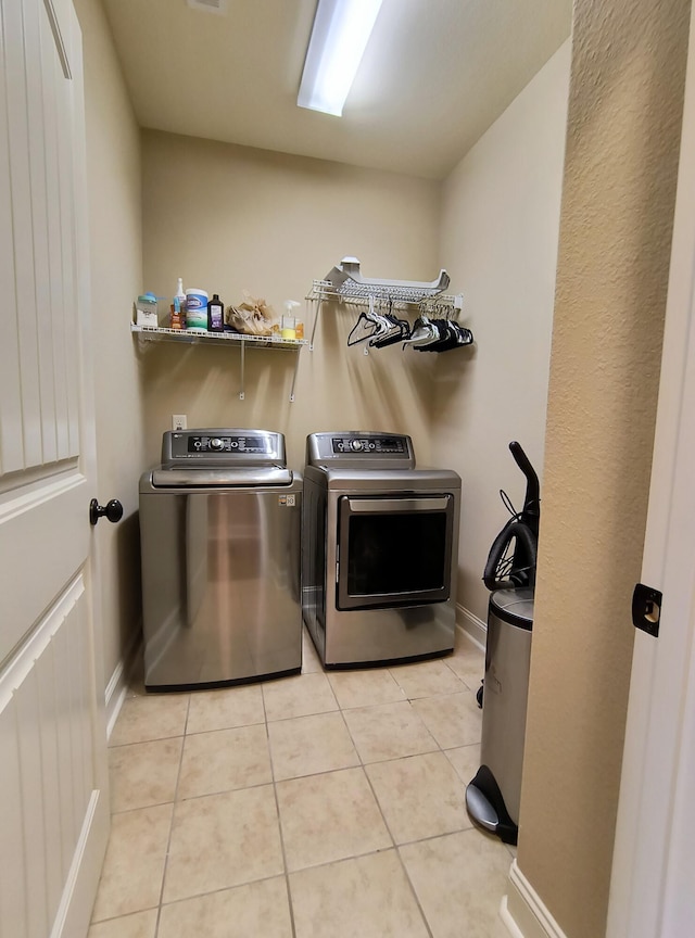 179 Trade Wind Dr, Fort Oglethorpe, GA 30742 - washroom with washing machine and clothes dryer and light tile patterned flooring