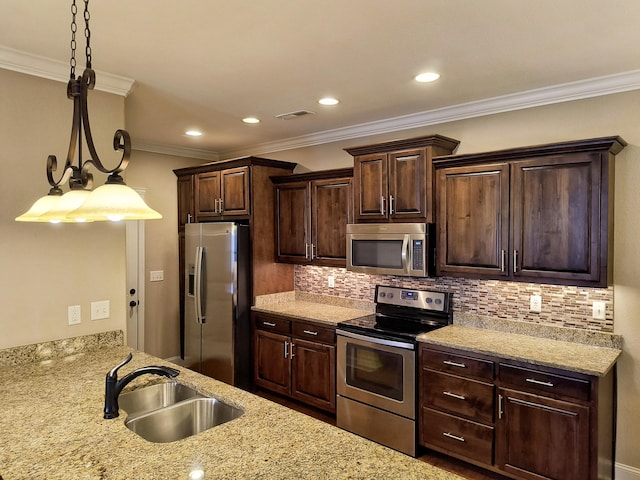179 Trade Wind Dr, Fort Oglethorpe, GA 30742 - kitchen with stainless steel appliances, dark brown cabinetry, tasteful backsplash, pendant lighting, and ornamental molding