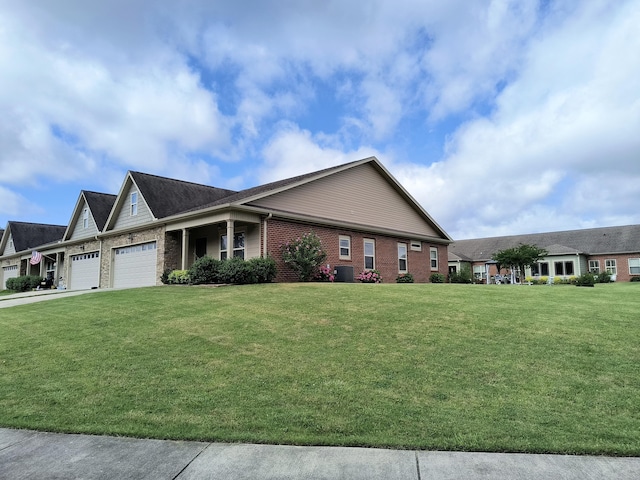 179 Trade Wind Dr, Fort Oglethorpe, GA 30742 - view of side of property with a garage, brick siding, a yard, and concrete driveway