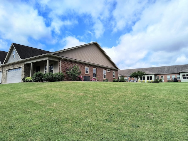 179 Trade Wind Dr, Fort Oglethorpe, GA 30742 - view of side of home with brick siding, a lawn, and an attached garage