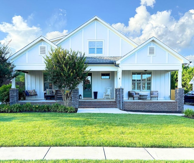3528 Morning Dew Cv, Apison, TN 37302 - craftsman-style home with a porch, a front lawn, outdoor lounge area, and board and batten siding
