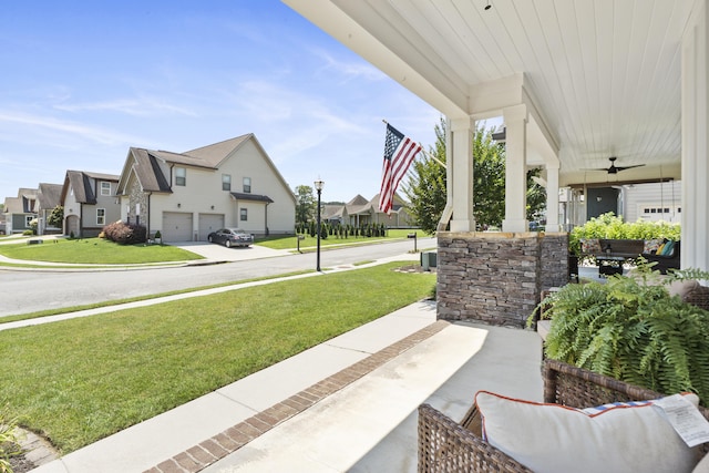 3528 Morning Dew Cv, Apison, TN 37302 - porch with a residential view, an attached garage, a lawn, and a ceiling fan