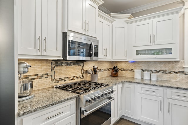 3528 Morning Dew Cv, Apison, TN 37302 - kitchen with appliances with stainless steel finishes, ornamental molding, white cabinets, and decorative backsplash
