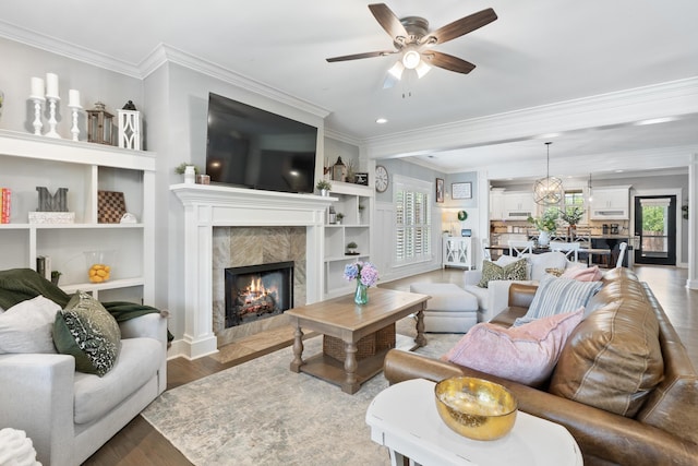 3528 Morning Dew Cv, Apison, TN 37302 - living area with ceiling fan, a fireplace, ornamental molding, wood finished floors, and built in shelves