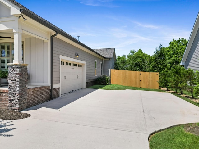 3528 Morning Dew Cv, Apison, TN 37302 - view of home's exterior featuring driveway, a garage, board and batten siding, and a gate