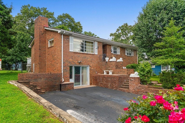 1339 Cloverdale Cir, Hixson, TN 37343 - back of property featuring a chimney, a patio area, and brick siding