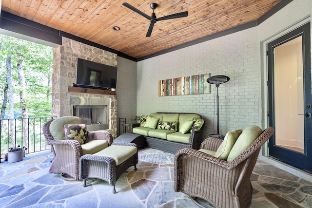 179 Rushing Water Trl, Rising Fawn, GA 30738 - living room featuring wooden ceiling, ceiling fan, stone floors, an outdoor stone fireplace, and brick wall