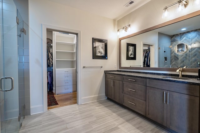 179 Rushing Water Trl, Rising Fawn, GA 30738 - full bath with double vanity, a spacious closet, a shower stall, and wood finished floors