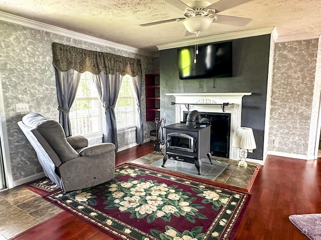 1467 Squire Fox Rd, Dandridge, TN 37725 - living room featuring crown molding, a wood stove, wallpapered walls, a ceiling fan, and a textured ceiling