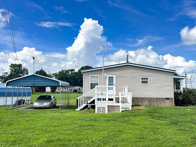 1467 Squire Fox Rd, Dandridge, TN 37725 - back of property with crawl space, a carport, a lawn, and driveway