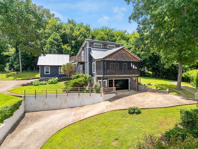 8223 Snow Hill Rd, Ooltewah, TN 37363 - view of front facade featuring a garage, a sunroom, concrete driveway, and a metal roof
