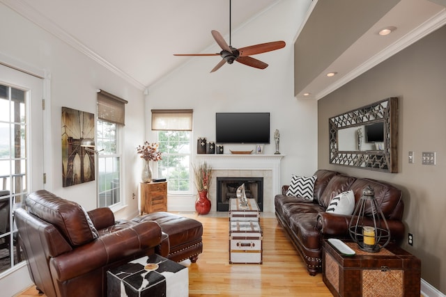 8223 Snow Hill Rd, Ooltewah, TN 37363 - living room featuring wood finished floors, a ceiling fan, ornamental molding, a tiled fireplace, and vaulted ceiling