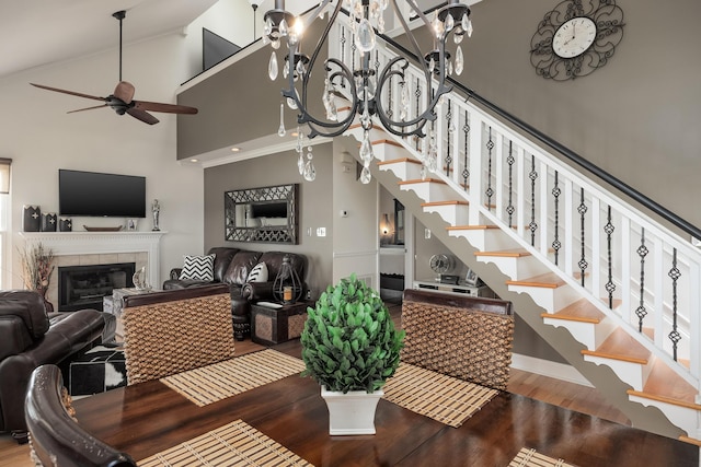 8223 Snow Hill Rd, Ooltewah, TN 37363 - dining room featuring wood finished floors, stairway, a chandelier, a fireplace, and a ceiling fan