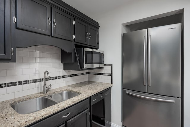 8223 Snow Hill Rd, Ooltewah, TN 37363 - kitchen with stainless steel appliances, tasteful backsplash, light stone countertops, and dark cabinetry