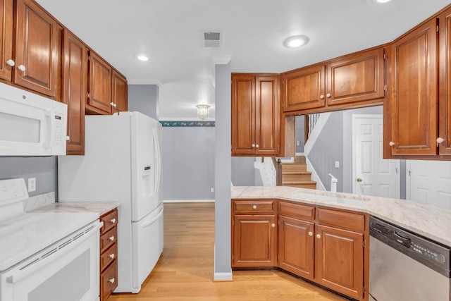 7414 Hamilton Run Dr, Chattanooga, TN 37421 - kitchen with white appliances, light wood-style floors, brown cabinetry, recessed lighting, and light stone countertops