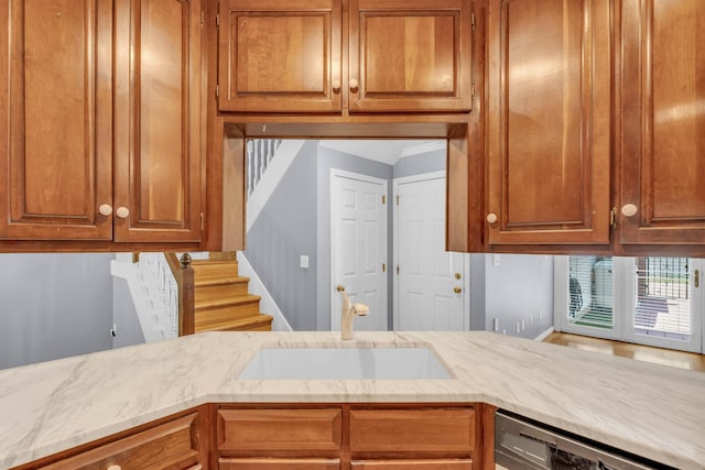 7414 Hamilton Run Dr, Chattanooga, TN 37421 - kitchen featuring dishwashing machine, light stone counters, and brown cabinetry