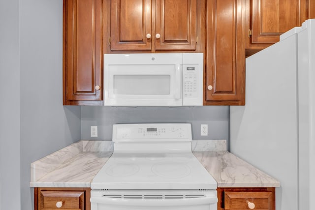 7414 Hamilton Run Dr, Chattanooga, TN 37421 - kitchen featuring white appliances, light countertops, and brown cabinets