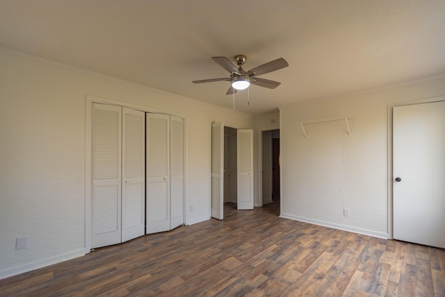 136 Cochran Dr NE, Dalton, GA 30721 - unfurnished bedroom with multiple closets, dark wood-type flooring, crown molding, and ceiling fan
