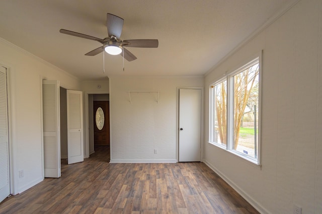 136 Cochran Dr NE, Dalton, GA 30721 - unfurnished bedroom with dark wood-style flooring, crown molding, and a ceiling fan