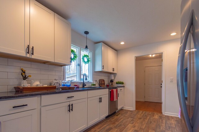 136 Cochran Dr NE, Dalton, GA 30721 - kitchen with stainless steel appliances, white cabinets, wood finished floors, backsplash, and recessed lighting