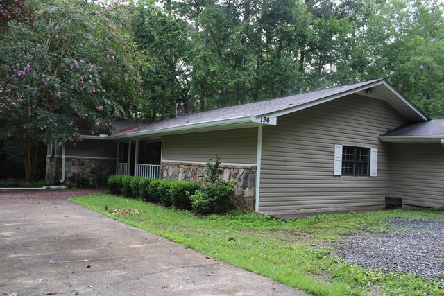 136 Cochran Dr NE, Dalton, GA 30721 - view of home's exterior featuring stone siding and a porch