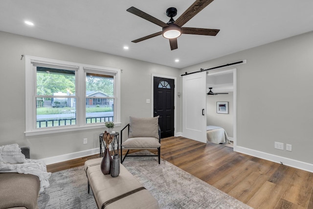 1610 Truman Ave, Chattanooga, TN 37412 - living area featuring ceiling fan, a barn door, wood finished floors, and recessed lighting