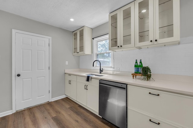 1610 Truman Ave, Chattanooga, TN 37412 - kitchen featuring dishwasher, dark wood-style flooring, tasteful backsplash, light countertops, and a textured ceiling