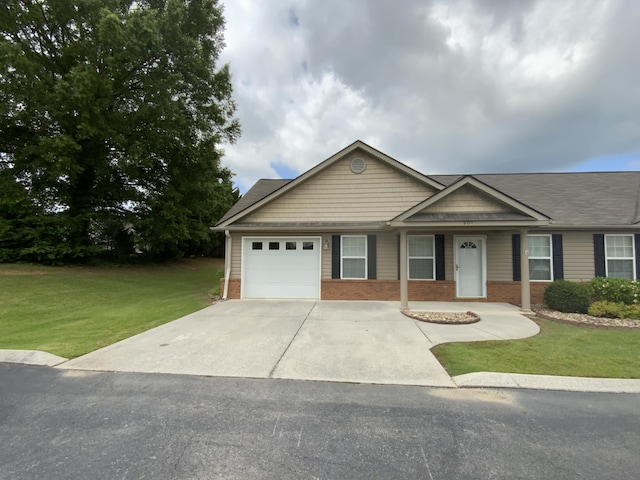 904 Cedar Creek Dr, Rossville, GA 30741 - ranch-style home with brick siding, concrete driveway, a front lawn, and a garage