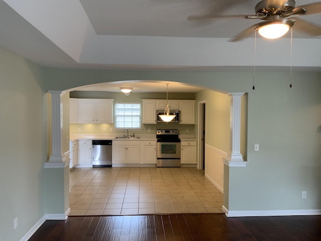 904 Cedar Creek Dr, Rossville, GA 30741 - kitchen with stainless steel appliances, decorative columns, arched walkways, and ceiling fan