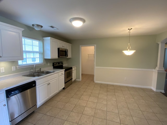 904 Cedar Creek Dr, Rossville, GA 30741 - kitchen with appliances with stainless steel finishes, light countertops, white cabinets, decorative light fixtures, and light tile patterned floors
