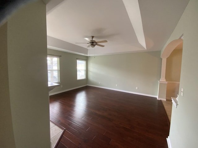 904 Cedar Creek Dr, Rossville, GA 30741 - unfurnished room with ceiling fan, wood finished floors, a tray ceiling, arched walkways, and decorative columns