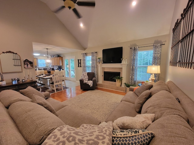 458 Fieldstone Dr, Ringgold, GA 30736 - living area featuring ceiling fan, light wood finished floors, healthy amount of natural light, high vaulted ceiling, and a tile fireplace