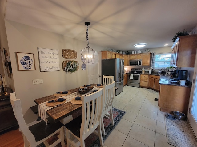 458 Fieldstone Dr, Ringgold, GA 30736 - dining area with light tile patterned flooring and a chandelier