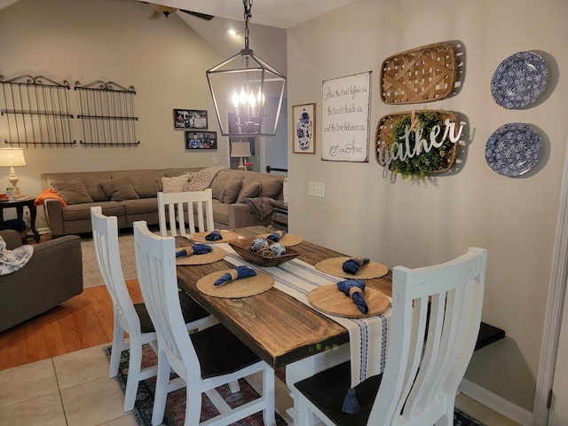 458 Fieldstone Dr, Ringgold, GA 30736 - tiled dining space with a chandelier and vaulted ceiling