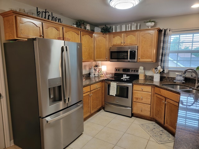 458 Fieldstone Dr, Ringgold, GA 30736 - kitchen with appliances with stainless steel finishes, light tile patterned floors, and brown cabinets