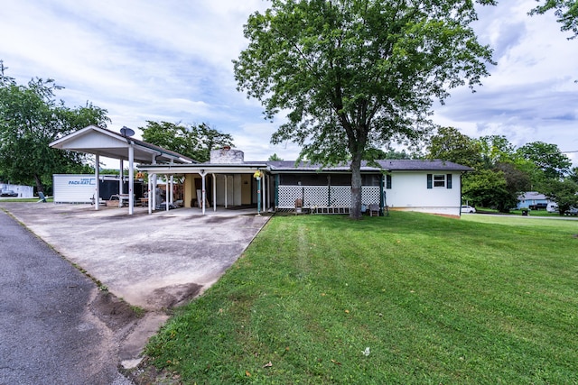 311 Birchwood St, Pikeville, TN 37367 - view of front of house with asphalt driveway, an attached carport, and a front lawn