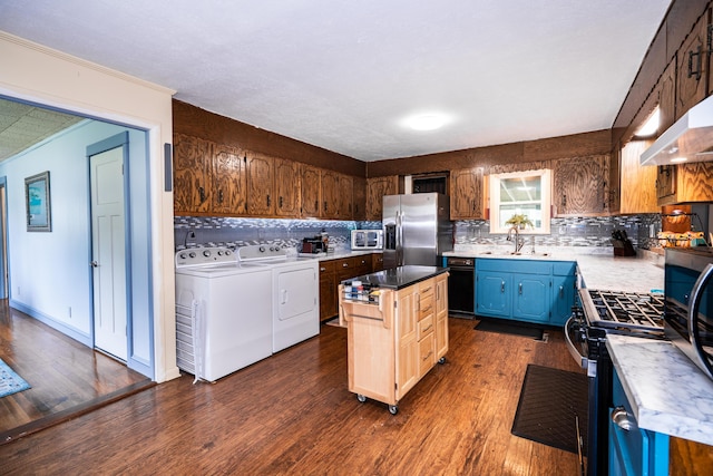311 Birchwood St, Pikeville, TN 37367 - kitchen with separate washer and dryer, appliances with stainless steel finishes, backsplash, dark wood-style floors, and a center island